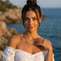 Thumbnail for Saona Triple Layer Necklace worn by a woman, featuring three gold chains, by Brother & Sisters, styled effortlessly.