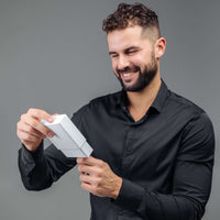 Thumbnail for Man excitedly unboxing the Minimalist Photo Bracelet from Brother & Sisters, featuring premium lava stones.
