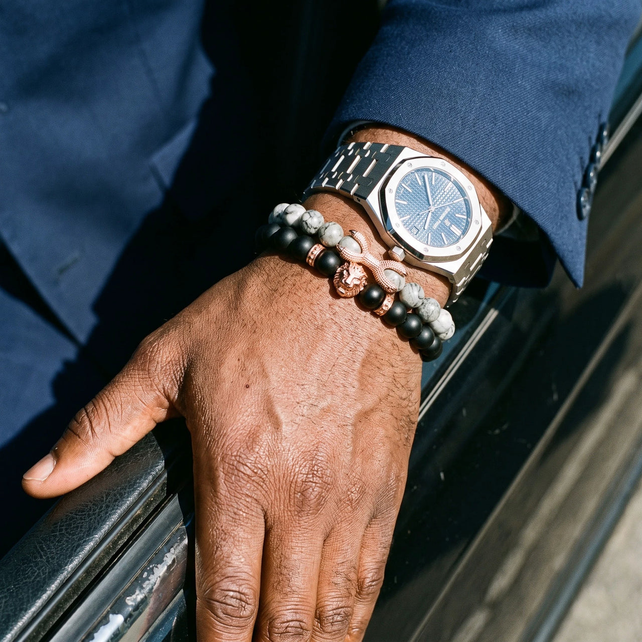 Rose Gold Lion with Black & Grey Stones Set – worn next to a luxury watch | Brother & Sisters | SKU: 21369621-rose-gold-XS-14-15, 21369621-rose-gold-S-16-17, 21369621-rose-gold-M-18-19, 21369621-rose-gold-L-20-21, 21369621-rose-gold-XL-22-23