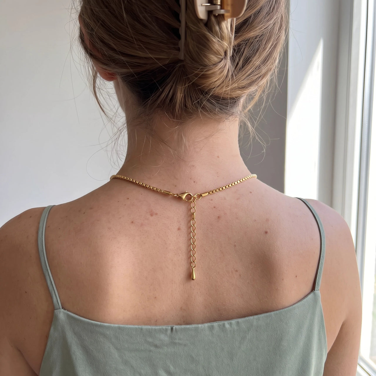 Back of the neck showing the lobster clasp and extension chain of the gold heart photo necklace | SKU: TPH-CHTN-GOLD-SMALL