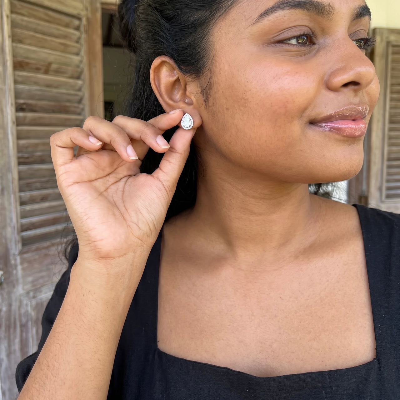Pear stud earrings — worn, everyday gesture, silver | SKU: 505174