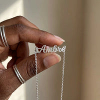 Thumbnail for Minimalist Name Necklace in silver pendant held between two fingertips showing its true size, the name Ambre | SKU: minimalistnn-silver